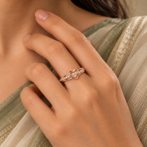 Amorette Ring in rose gold, worn snugly on a model's hand beside elegant elegant ivory or soft sage saree with proper draping and a modest covered chest