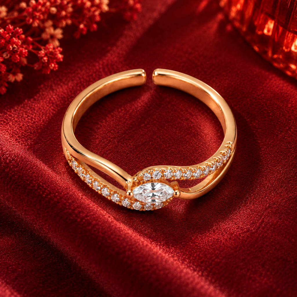 Seraphine Ring in rose gold, from a high angle on burgundy satin with warm festive bokeh