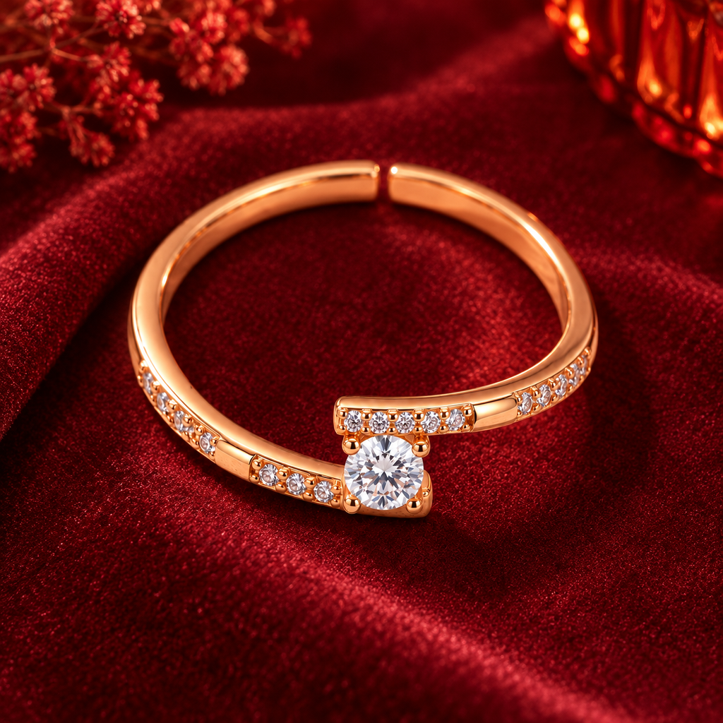 Clarisse Ring in rose gold, from a high angle on burgundy satin with warm festive bokeh