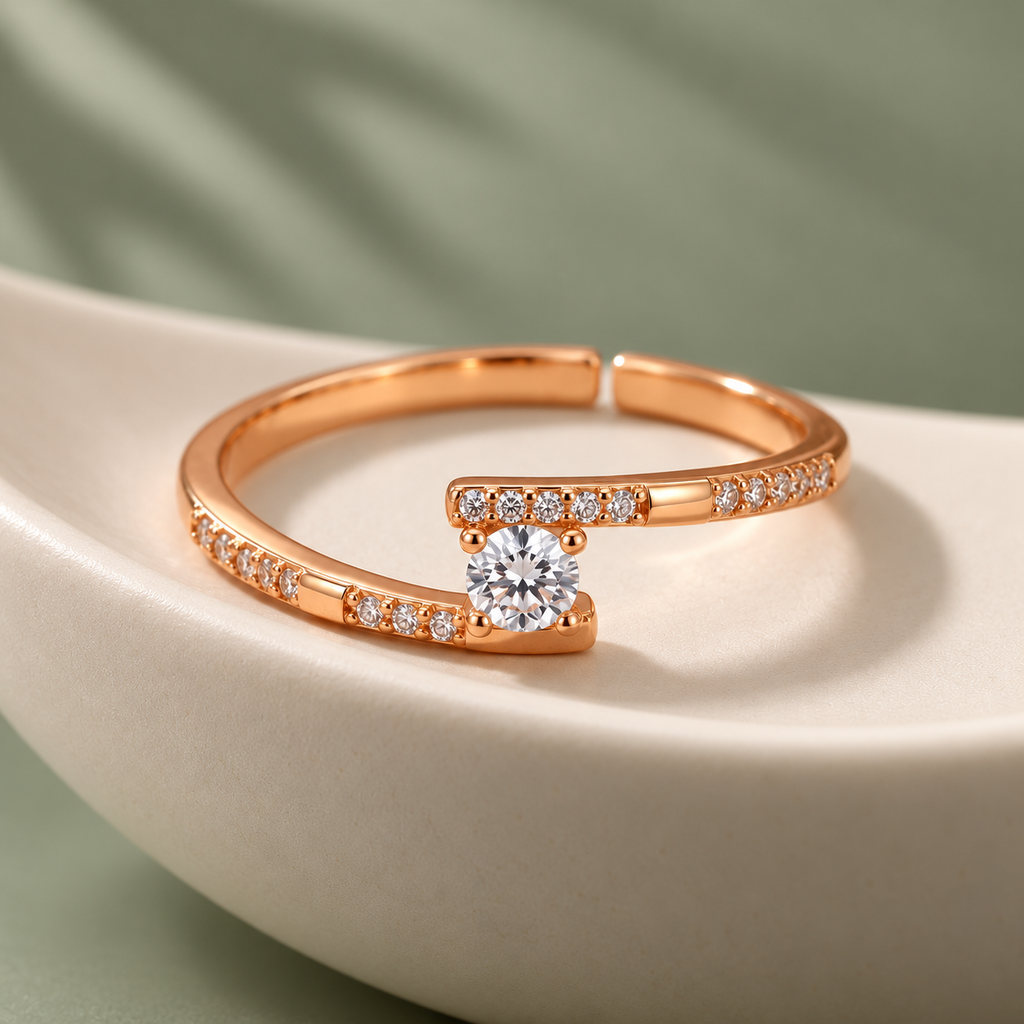 Clarisse Ring rose gold plated offset solitaire ring in an ivory porcelain bowl against sage