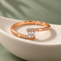 Clarisse Ring rose gold plated offset solitaire ring in an ivory porcelain bowl against sage