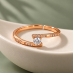 Clarisse Ring rose gold plated offset solitaire ring in an ivory porcelain bowl against sage