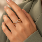 Evangeline rose gold plated crossover ring — model hand in premium editorial lighting