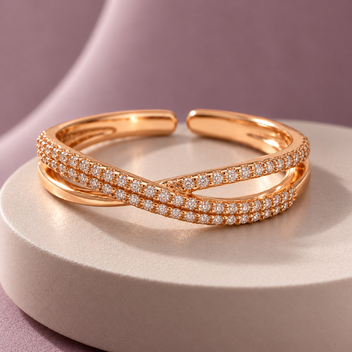 Evangeline rose gold plated crossover ring — mauve pedestal in premium editorial lighting