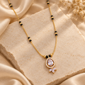 Pallavi Mangalsutra with a teardrop halo pendant and three marquise accents on ivory stone and champagne silk