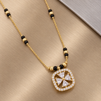 Close-up of Rajshree Mangalsutra's rounded-square halo and openwork pinwheel centre on brushed metal