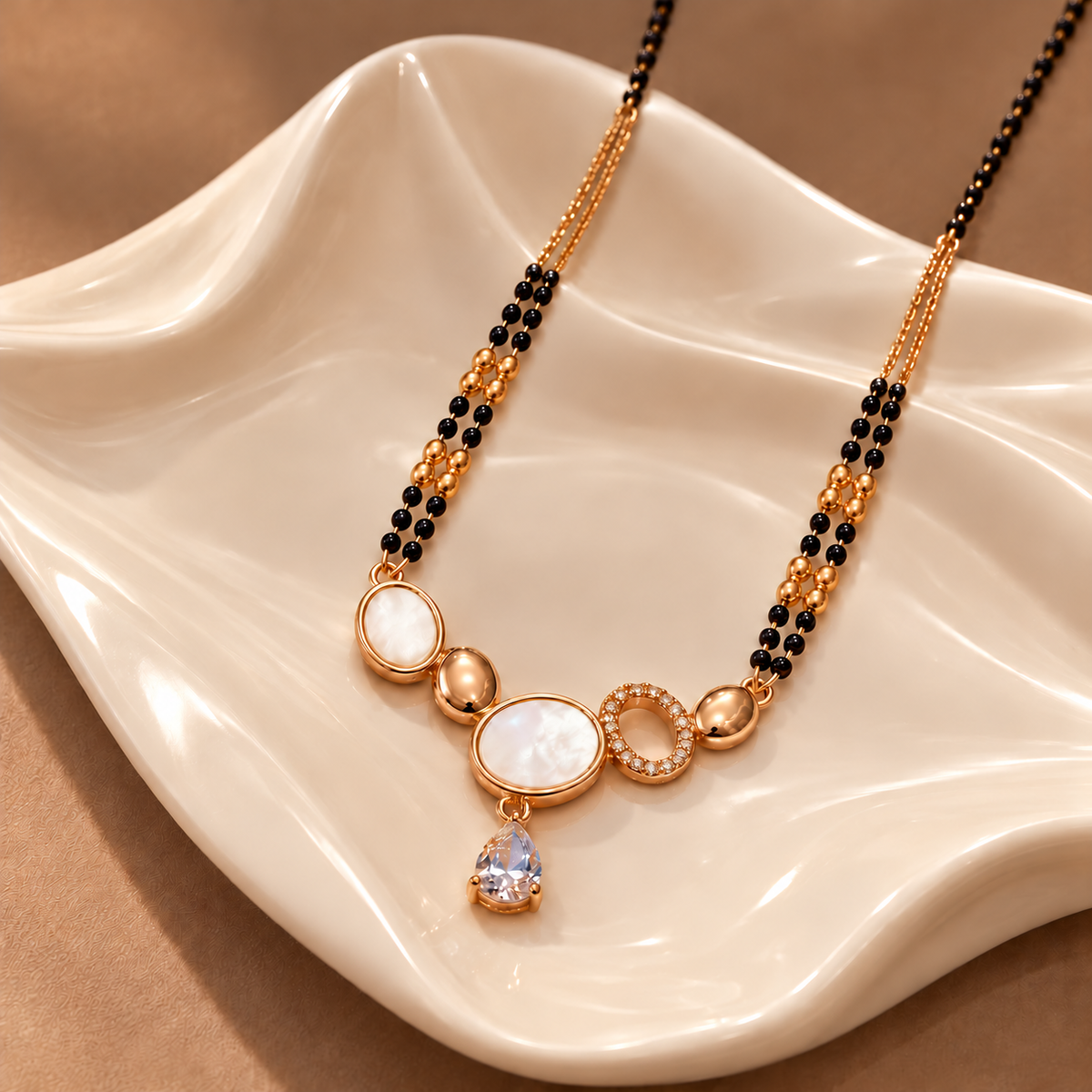 Renelle Mangalsutra angled on ivory ceramic