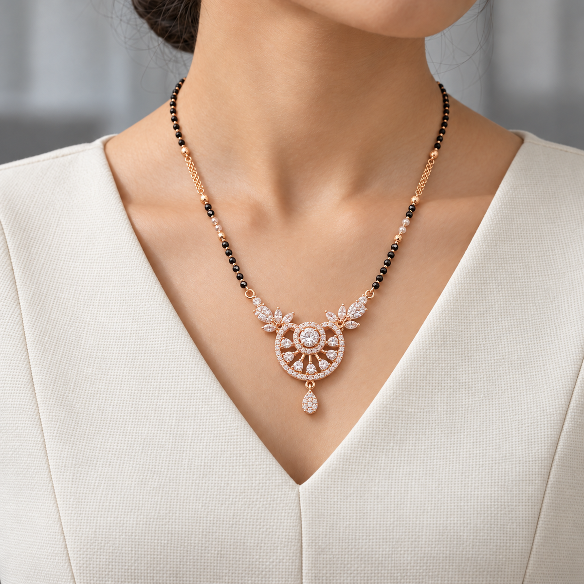 Soleia Mangalsutra worn with an ivory woven V-neck dress, showing the pendant and black bead chain.