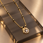 Angled view of Tarini Mangalsutra on smoked glass and brushed champagne metal