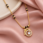 Detail of Tarini Mangalsutra's clear round centre, circular halo and tiny pink accent on blush silk