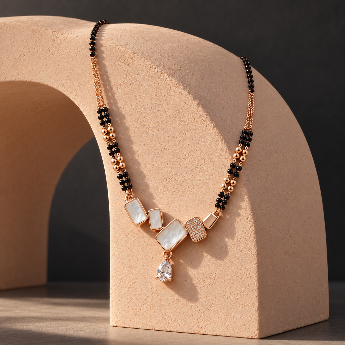 Valenne Mangalsutra on a sculptural peach-plaster arch