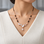 Valenne Mangalsutra worn with an ivory woven V-neck dress, showing the pendant and black bead chain.