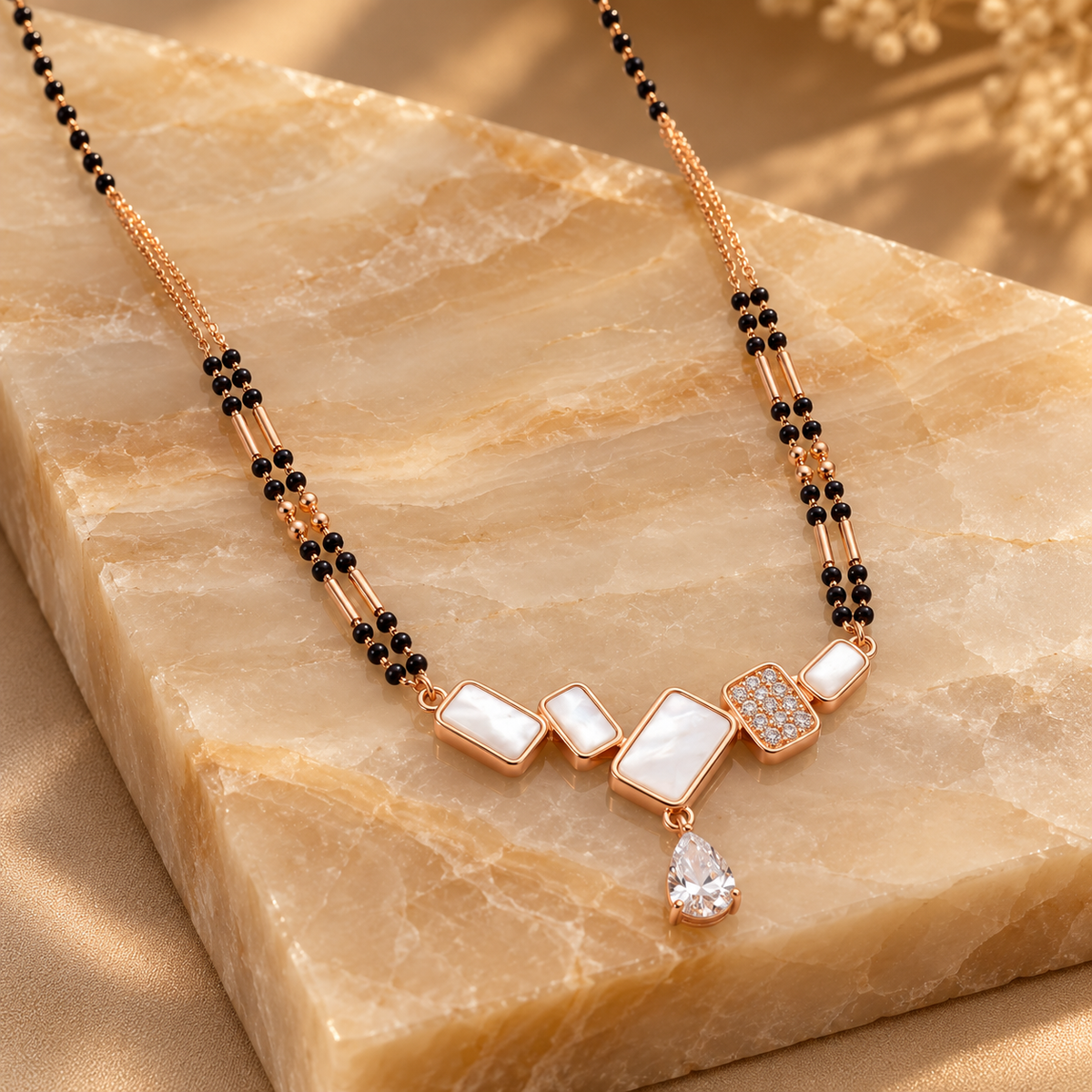 Geometric mangalsutra on a polished champagne onyx slab